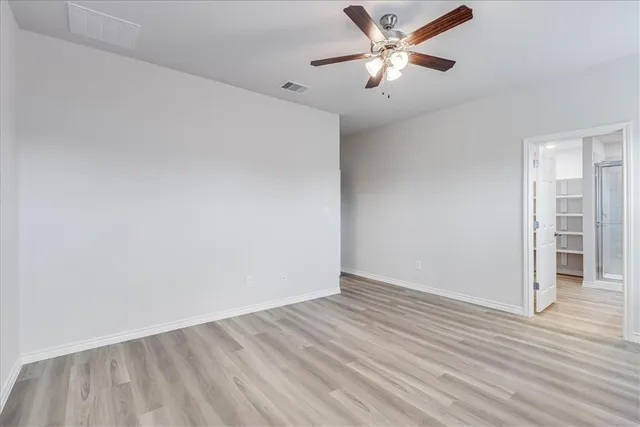 a view of an empty room and a window