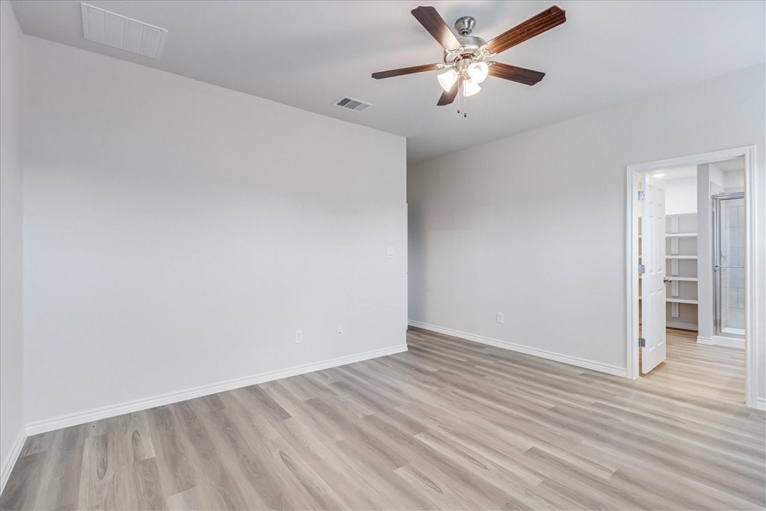 1634 Comfy Way Corpus Christi, TX 78418 - Photo 18 of 39 an empty room with wooden floor and a ceiling fan with wooden floor