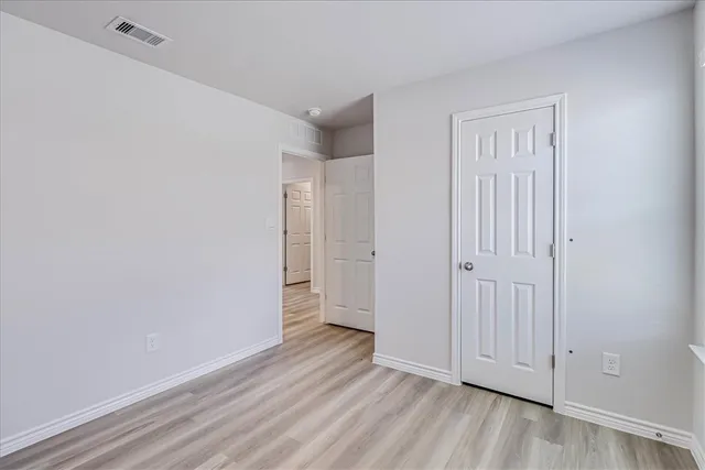 a view of an empty room and wooden floor
