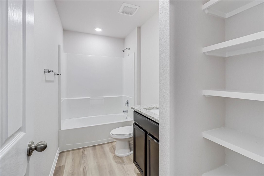 1634 Comfy Way Corpus Christi, TX 78418 - Photo 27 of 39 a bathroom with a sink a toilet and shower
