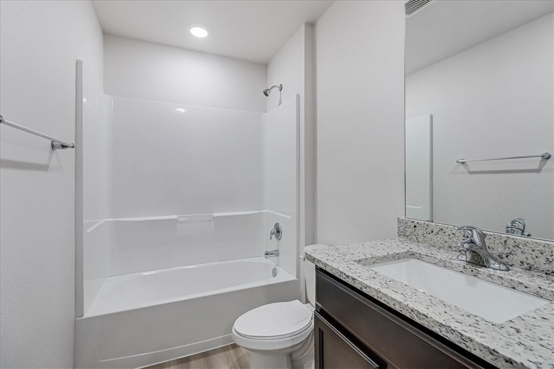 1634 Comfy Way Corpus Christi, TX 78418 - Photo 28 of 39 a bathroom with a granite countertop sink toilet and shower