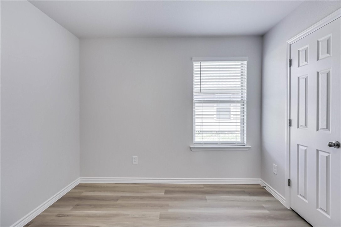 1634 Comfy Way Corpus Christi, TX 78418 - Photo 30 of 39 a view of an empty room with wooden floor and a window