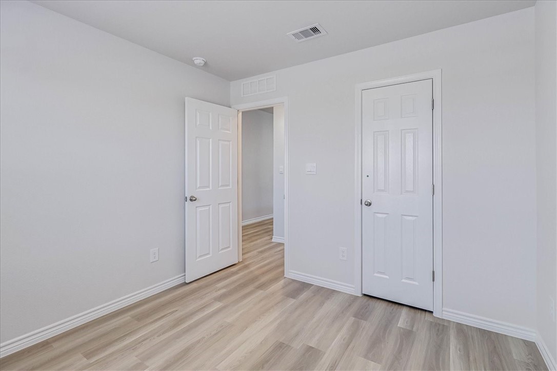1634 Comfy Way Corpus Christi, TX 78418 - Photo 32 of 39 a view of an empty room and wooden floor