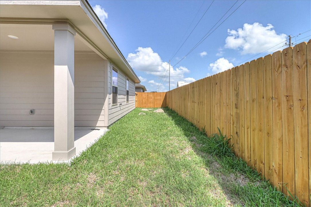 1634 Comfy Way Corpus Christi, TX 78418 - Photo 38 of 39 a view of a back yard with yellow lighting