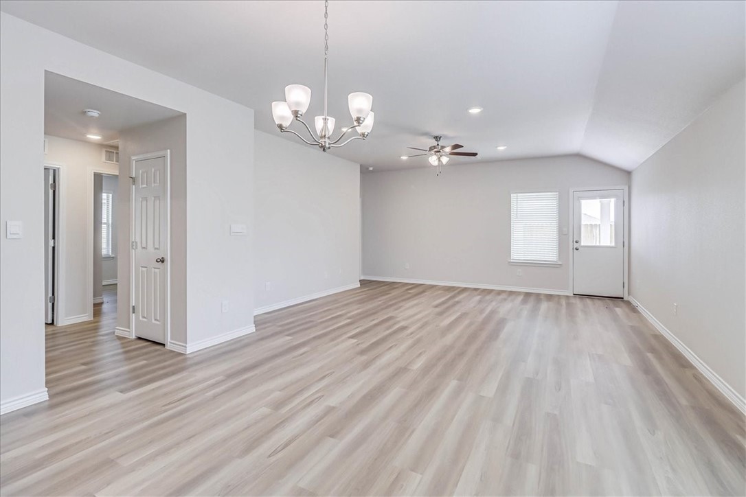 1634 Comfy Way Corpus Christi, TX 78418 - Photo 7 of 39 a view of an empty room with wooden floor and a window