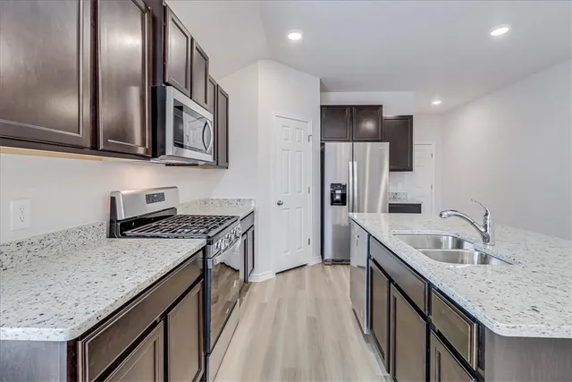 a kitchen with granite countertop a stove and a sink