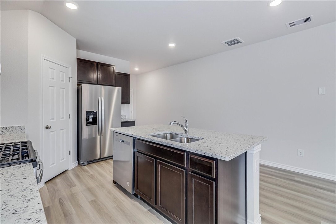 1634 Comfy Way Corpus Christi, TX 78418 - Photo 9 of 39 a kitchen with stainless steel appliances granite countertop a sink stove and refrigerator