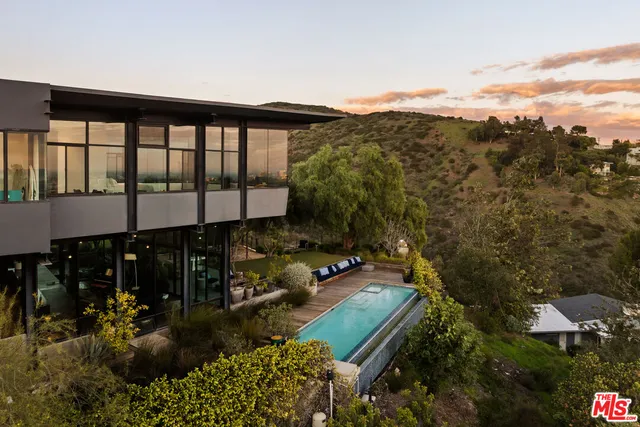 a aerial view of a house with a garden and lake view