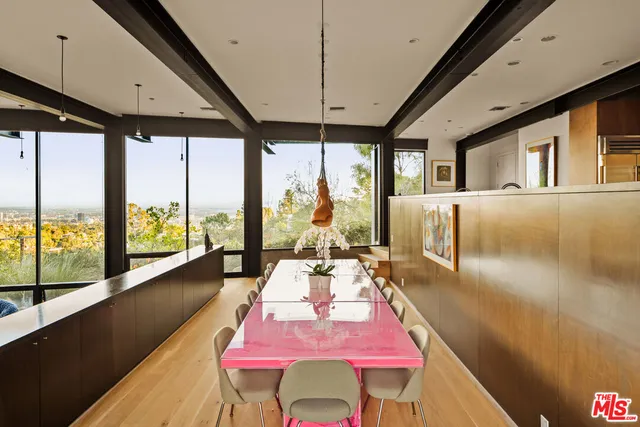 a bedroom with a bed and large windows