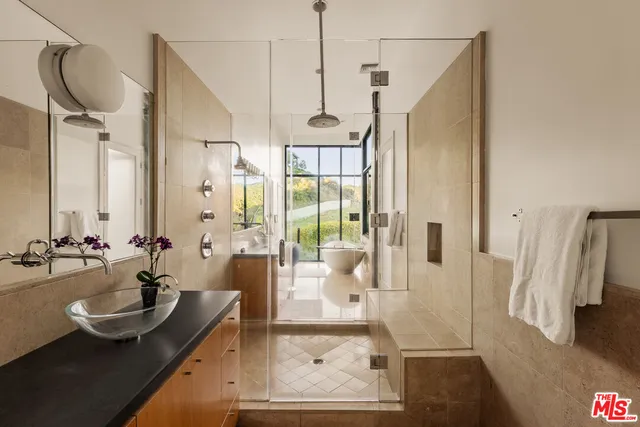 a bathroom with a couch and a large mirror