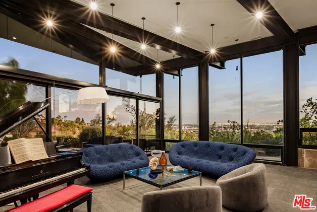 a living room with furniture and a book shelf