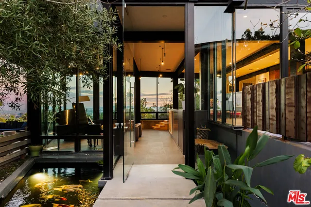 a dining room with furniture and a floor to ceiling window