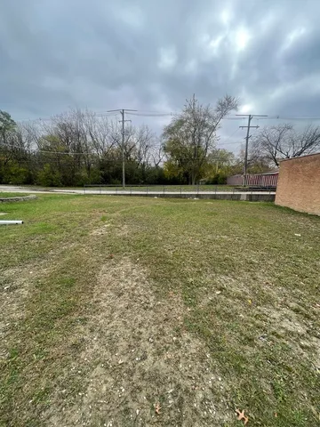 a view of a field with an ocean