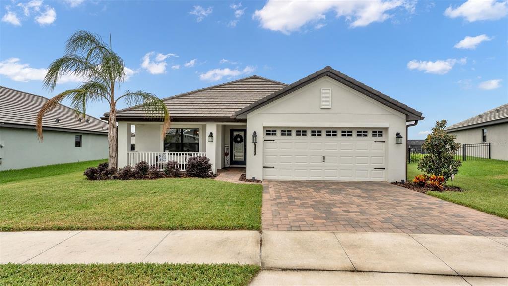 a view of a house with a yard and garage