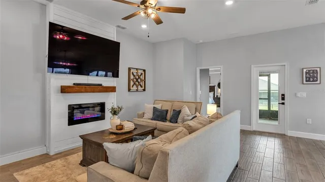 a living room with furniture fireplace and a flat screen tv