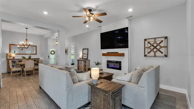 a living room with furniture and a view of kitchen