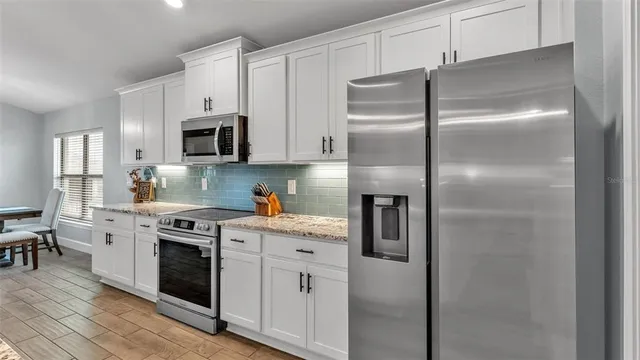 a kitchen with stainless steel appliances granite countertop a stove and refrigerator