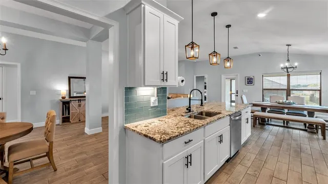 a kitchen with stainless steel appliances granite countertop a sink stove and window