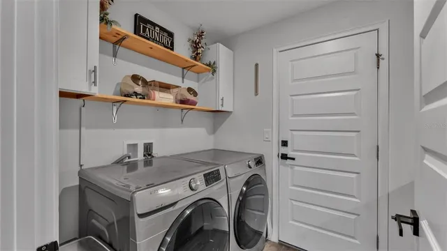 a kitchen with a sink and a stove with white countertops