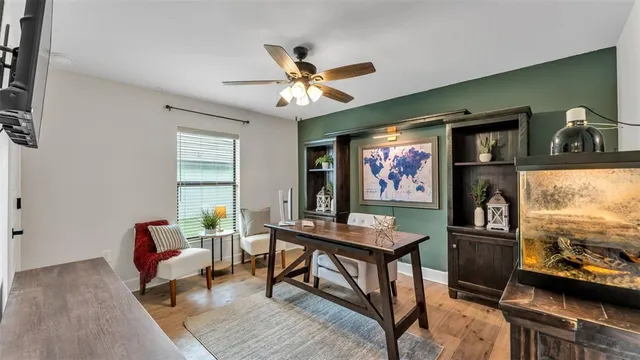 a living room with patio furniture and a floor to ceiling window