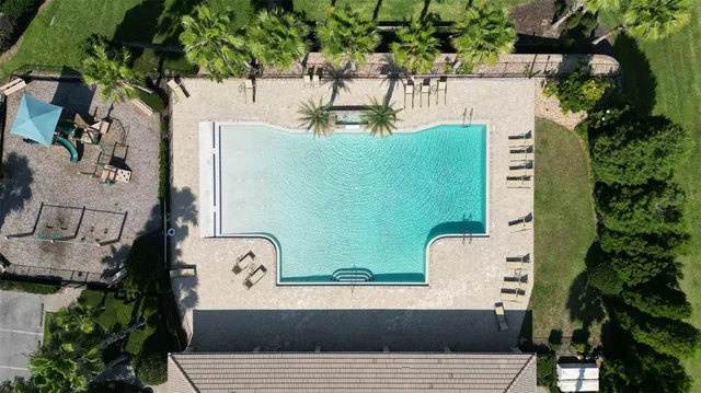 an aerial view of residential houses with outdoor space and lake view