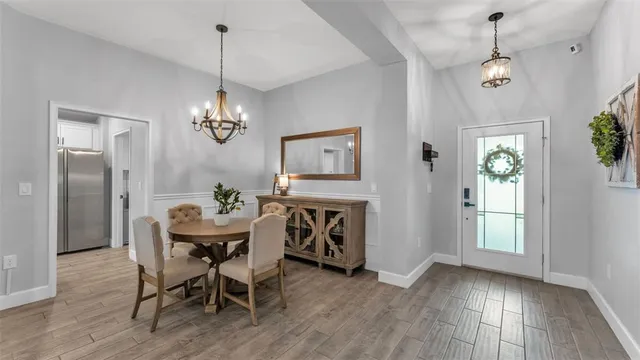 a view of a hallway with wooden floor and windows