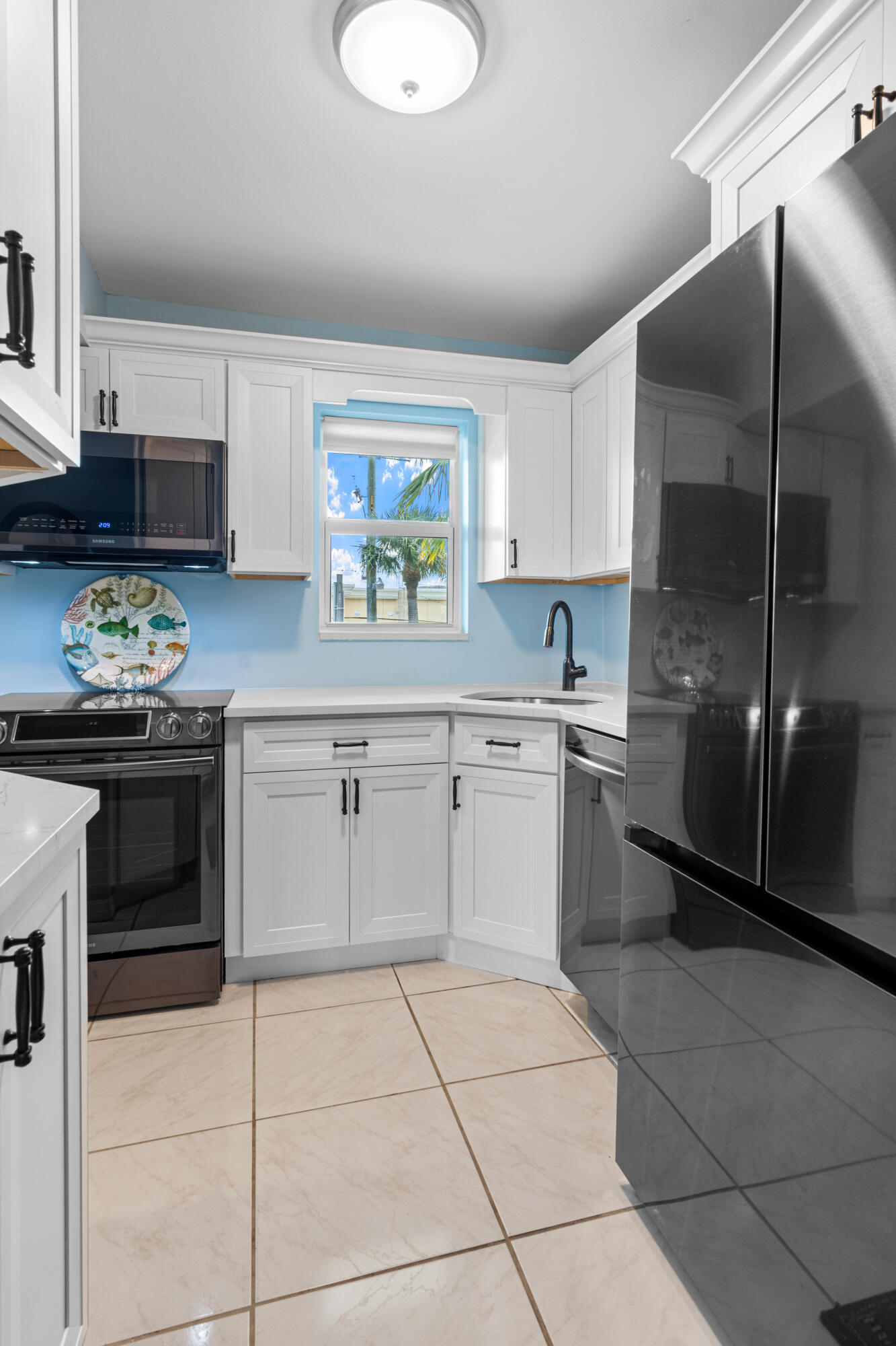 1981 Southwest Palm City Road, Unit 42H Stuart, FL 34994 - Photo 4 of 43 a kitchen with stainless steel appliances a stove a sink and a refrigerator