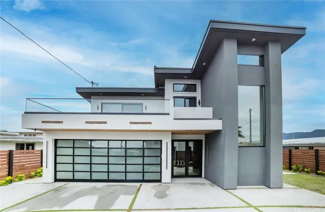 a living room with stainless steel appliances furniture wooden floor and a view of kitchen