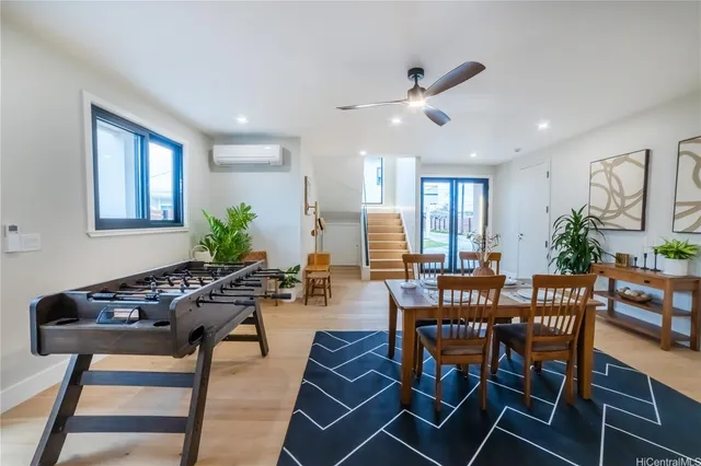 a kitchen with stainless steel appliances kitchen island granite countertop a table chairs sink and cabinets