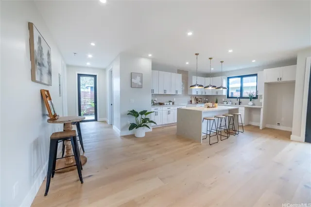 a view of a dining room with furniture and a kitchen