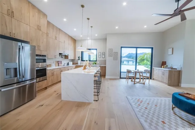 a large kitchen with a table and chairs