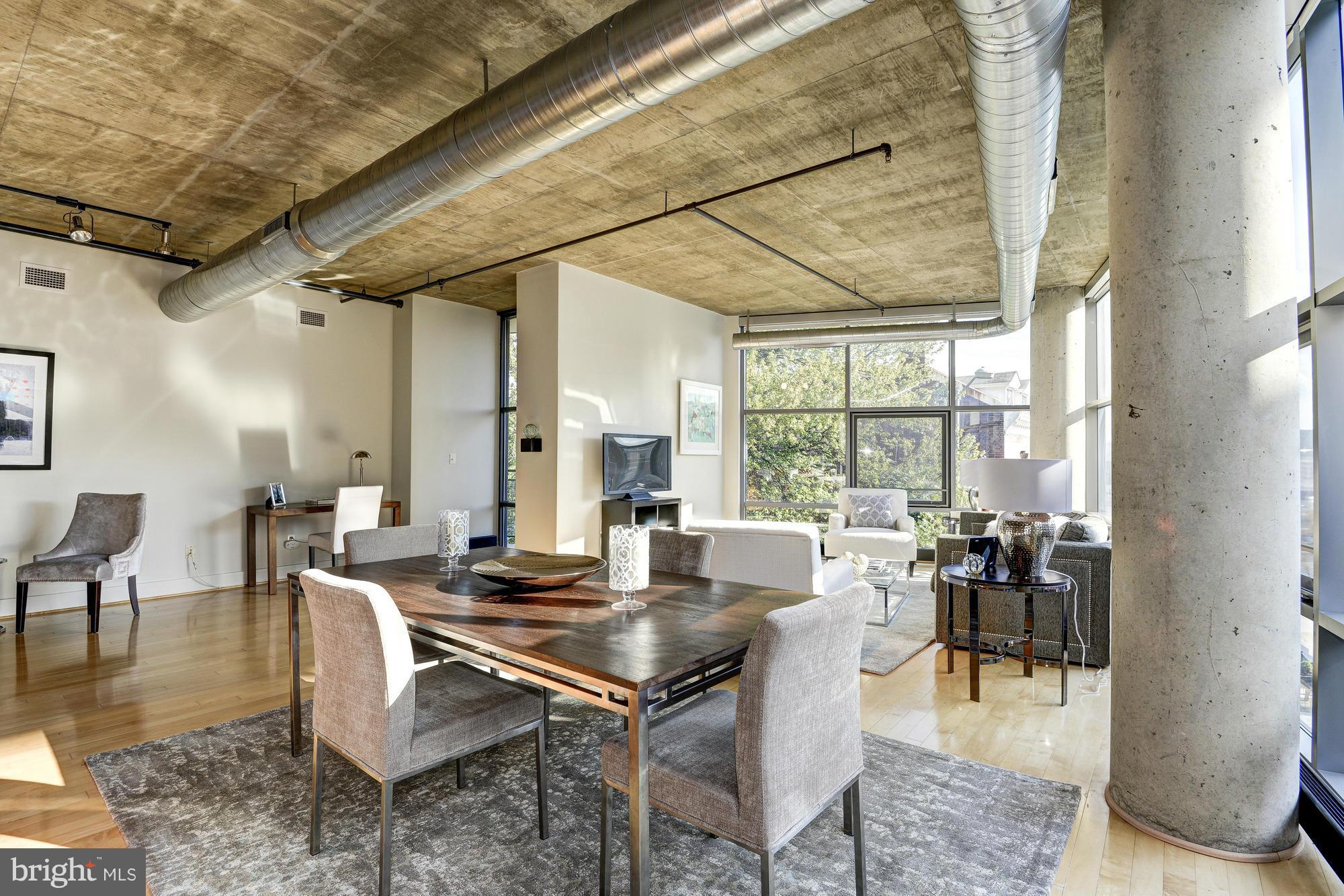 2301 Champlain Street Northwest, Unit 208 Washington, DC 20009 - Photo 2 of 30 a dining room with lots of furniture and large windows