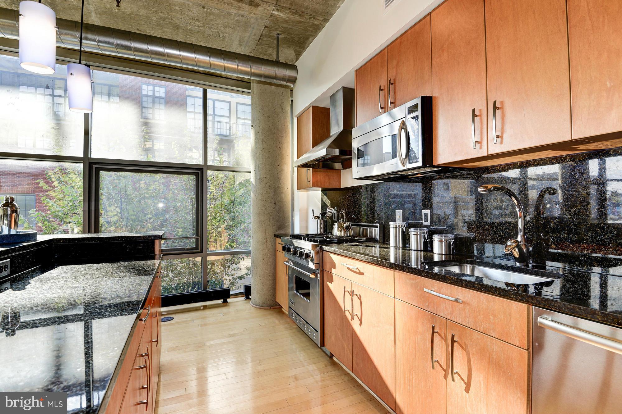 2301 Champlain Street Northwest, Unit 208 Washington, DC 20009 - Photo 12 of 30 a kitchen with stainless steel appliances granite countertop a stove and cabinets