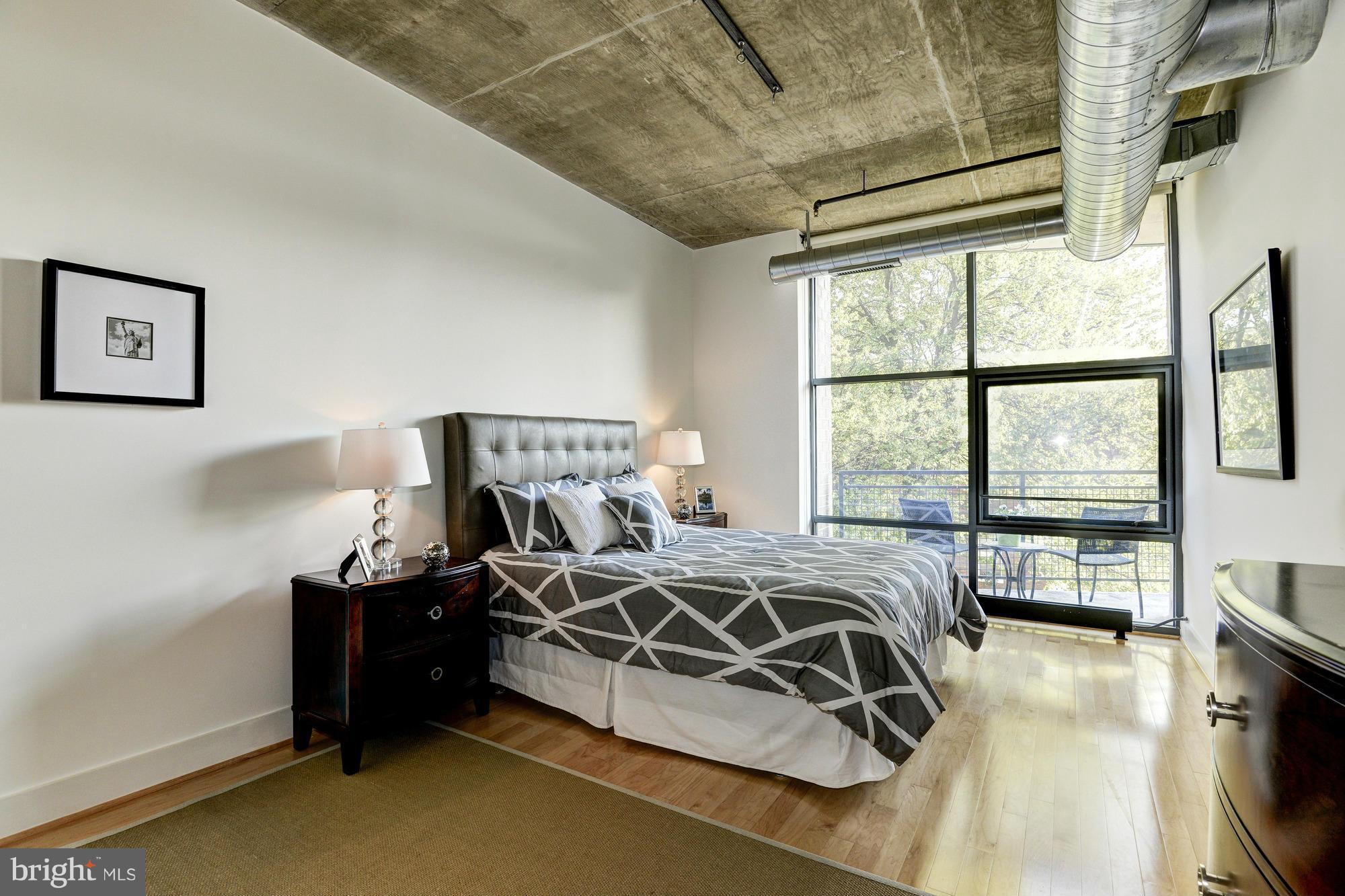 2301 Champlain Street Northwest, Unit 208 Washington, DC 20009 - Photo 17 of 30 a bedroom with a bed and a large window