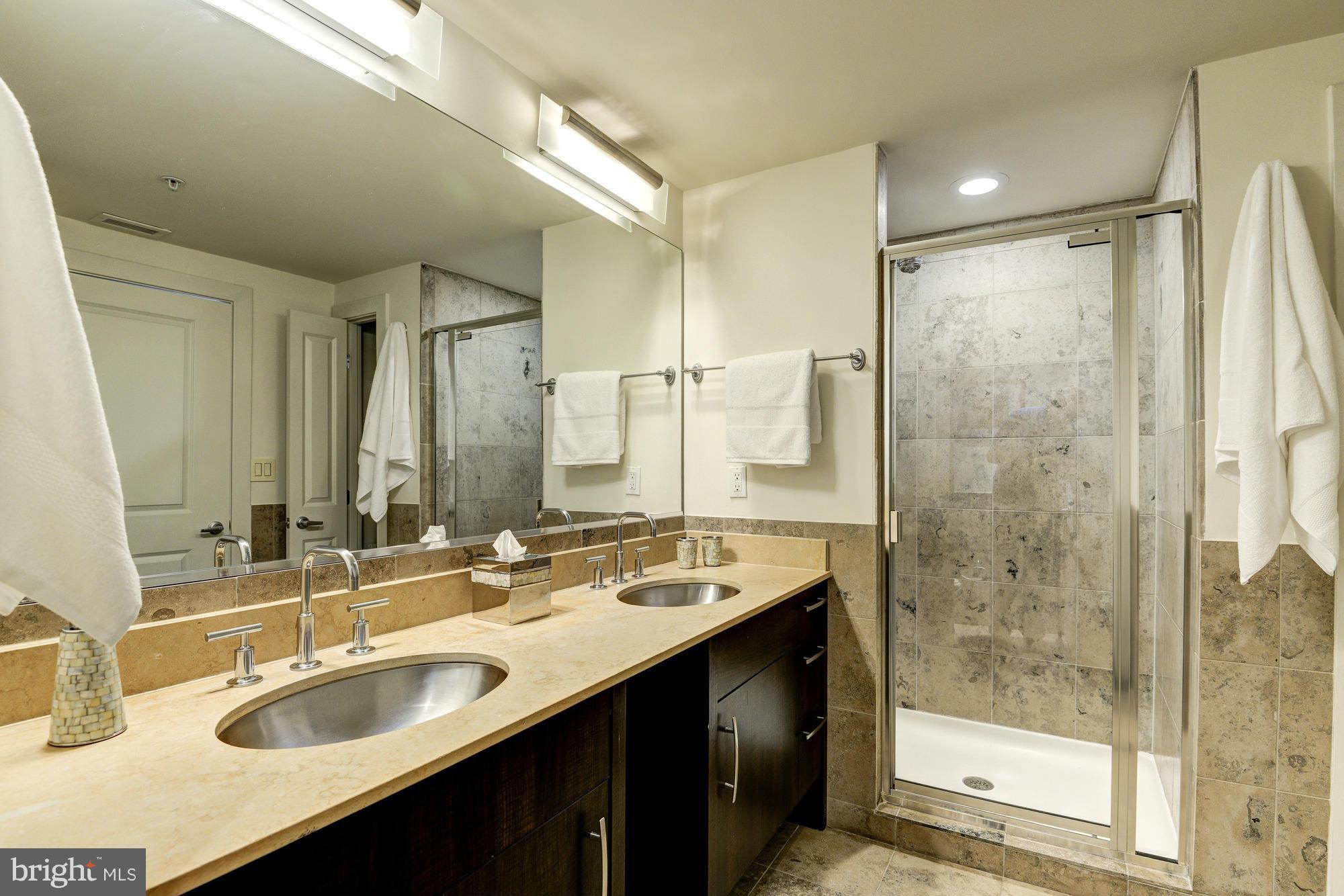 2301 Champlain Street Northwest, Unit 208 Washington, DC 20009 - Photo 19 of 30 a bathroom with a granite countertop sink mirror and double