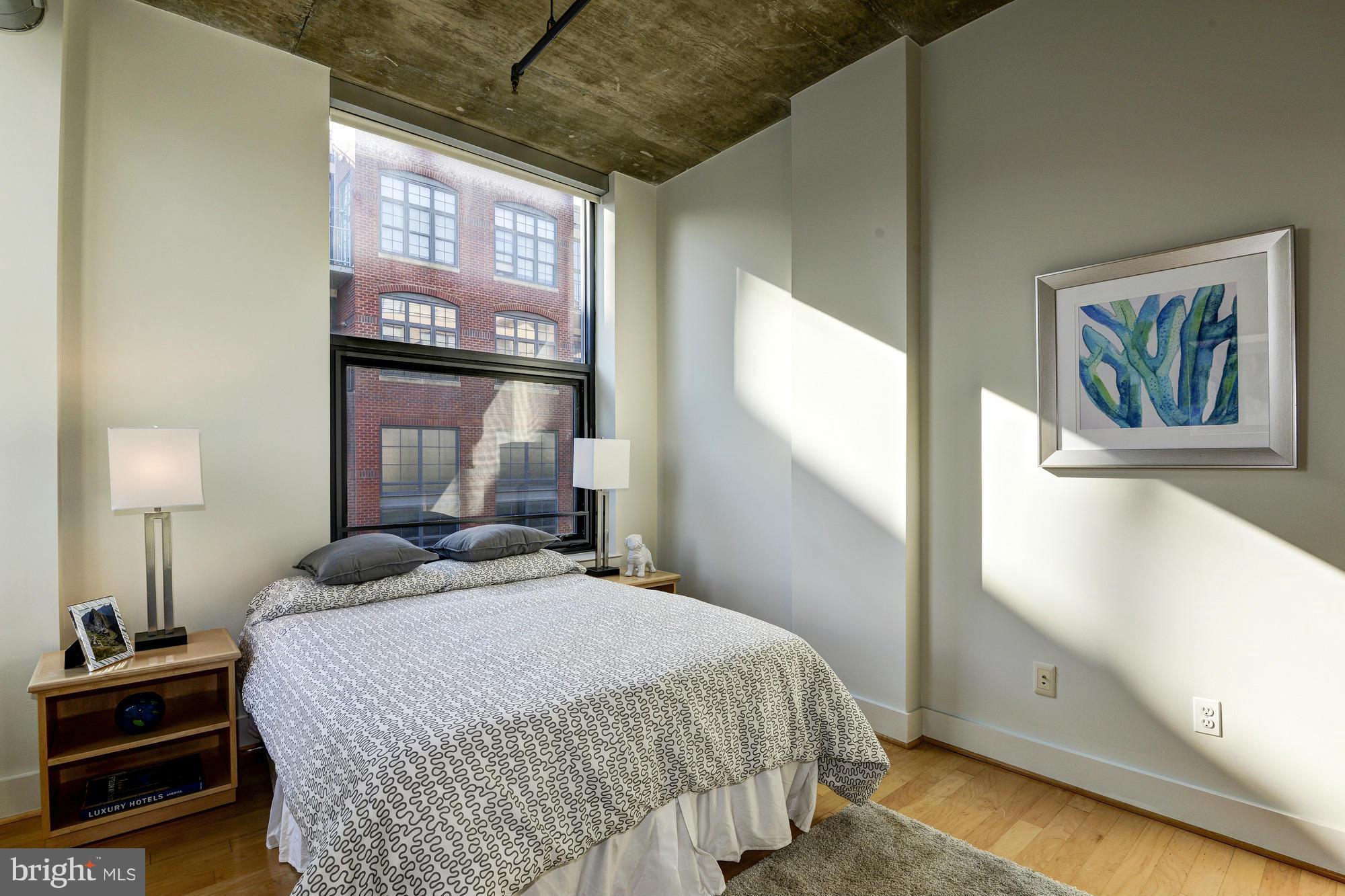 2301 Champlain Street Northwest, Unit 208 Washington, DC 20009 - Photo 21 of 30 a bedroom with a bed and a night stand