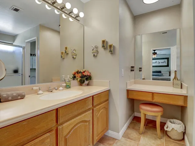 a bathroom with a sink a mirror and a light fixture