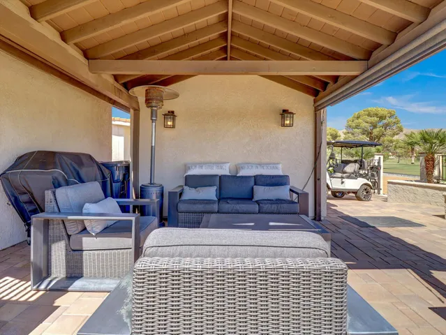 a view of a patio with table and chairs with wooden floor and fence