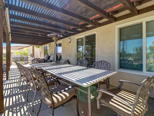 a view of a patio with swimming pool table and chairs