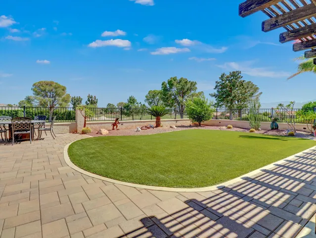 a view of a house with a backyard patio and swimming pool
