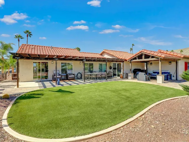 a view of a house with a yard porch and sitting area