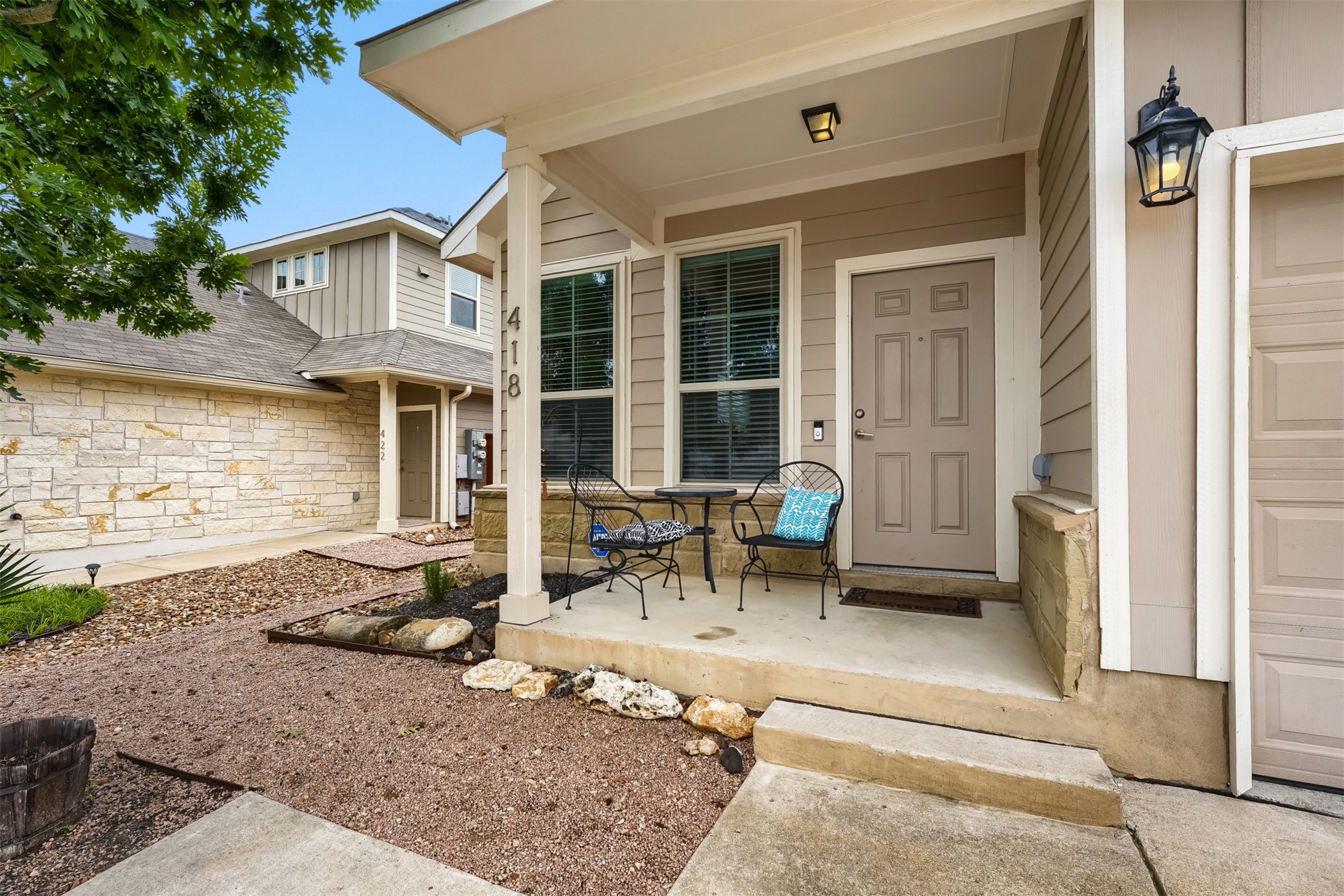 418 High Tech Drive Georgetown, TX 78626 - Photo 31 of 34 Inviting front porch featuring a paneled entry door, adjacent window with blinds, and exterior lantern lighting