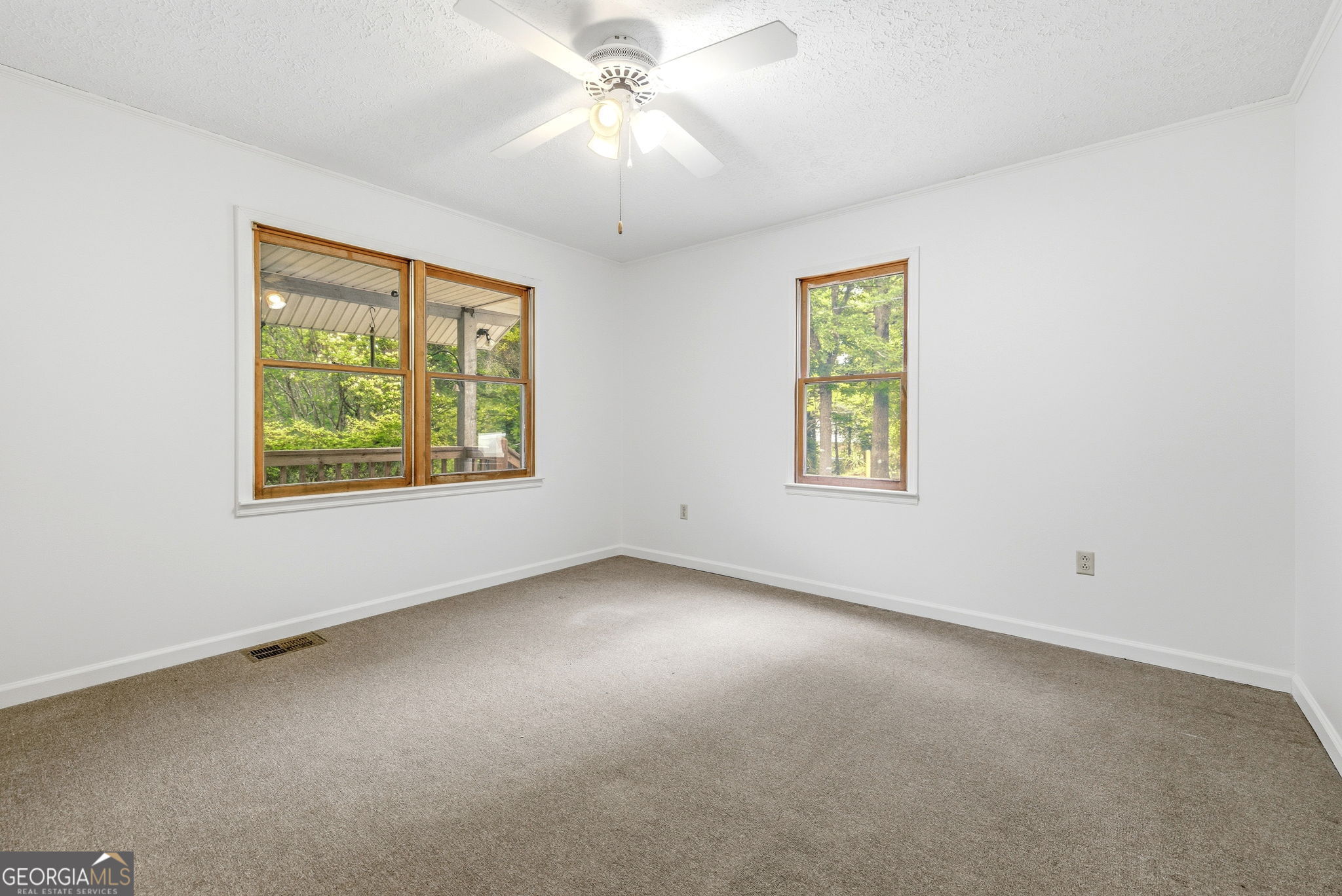 210 Kentucky Street Demorest, GA 30535 - Photo 21 of 30 an empty room with windows and chandelier fan