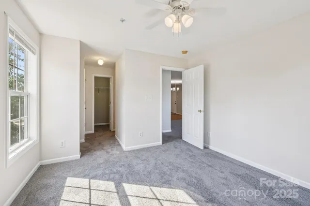 an empty room with windows and closet