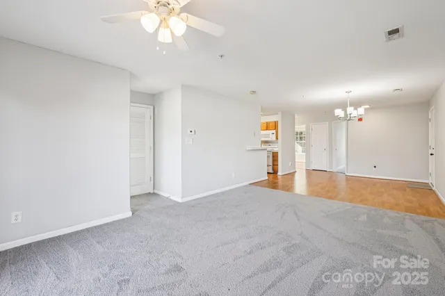 a view of an empty room with a kitchen