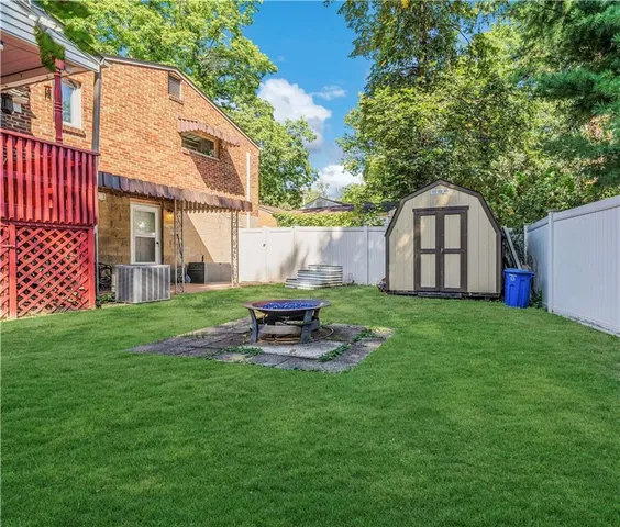 an aerial view of a house with outdoor space pool seating area and yard