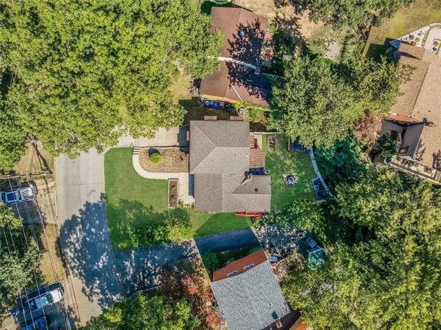 a front view of a house with a garden and yard