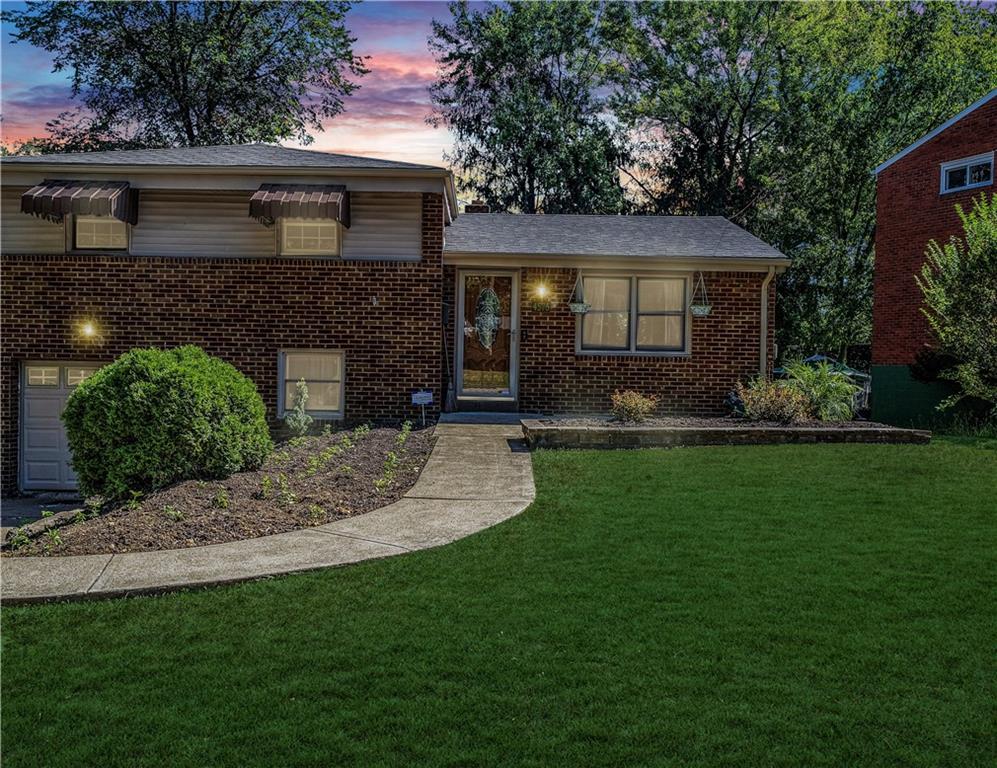 4576 Gates Drive Homestead, PA 15120 - Photo 17 of 17 a front view of a house with a garden and yard