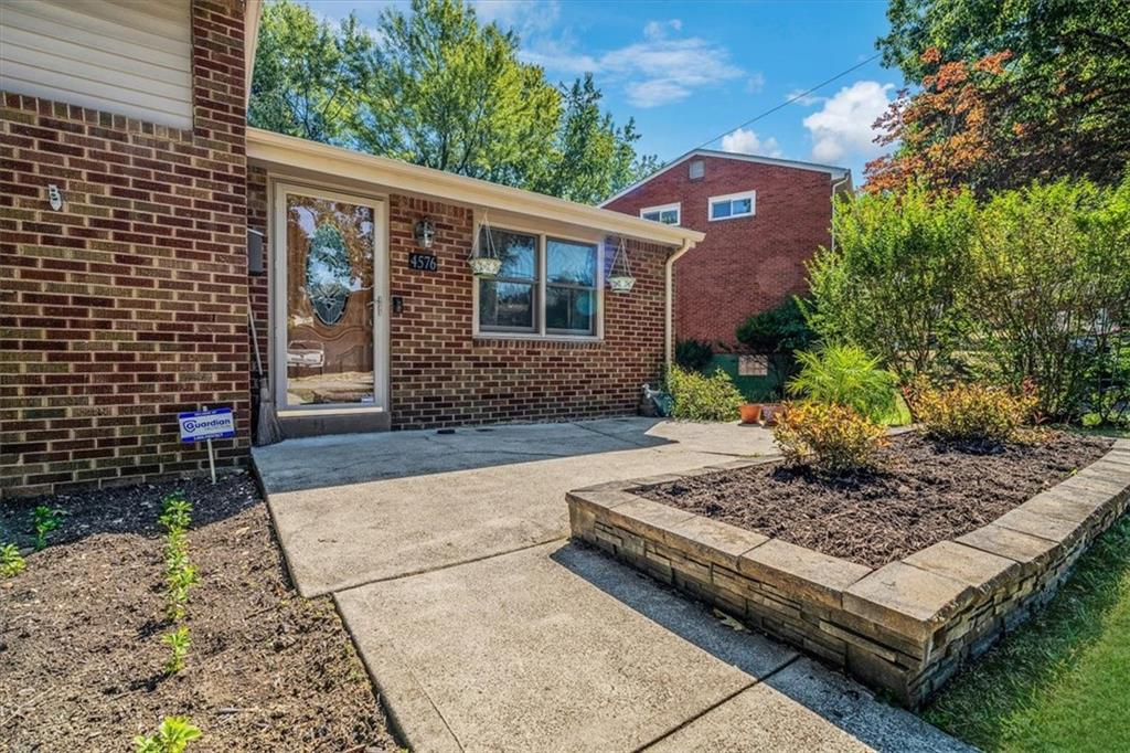 4576 Gates Drive Homestead, PA 15120 - Photo 2 of 17 a front view of a house with garden