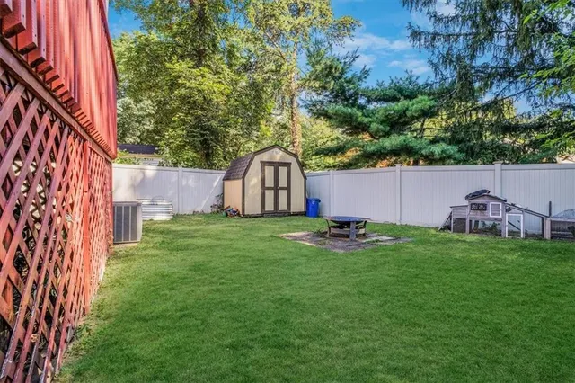 a backyard of a house with table and chairs